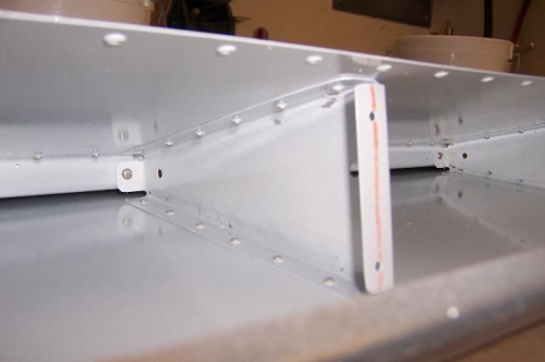 Ribs riveted to top and bottom skin