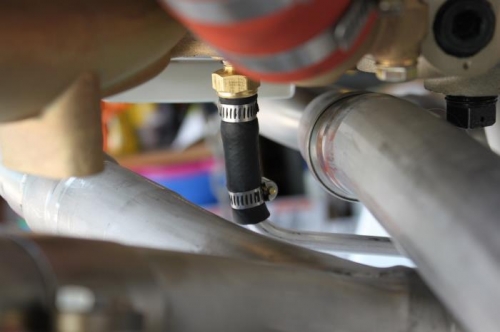 3/8 rubber fuel line couples aluminum drain line to sniffle valve.