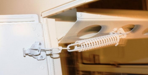 Spring Prevents Abrupt Stoppage of Door Swing