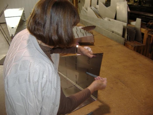 Carole de-burrs the drill holes