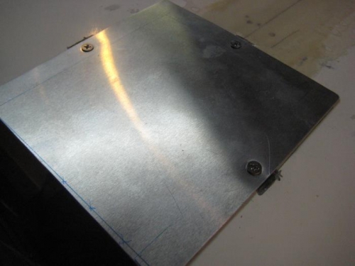 And the unpainted fuel door screwed in place.