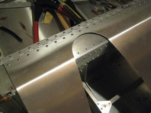 Forward edge of seat pan, over spar tunnel