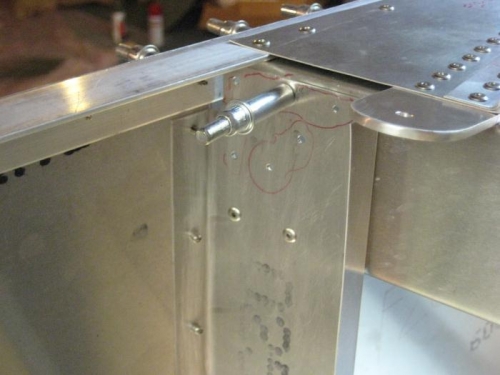 The seatbelt attach bracket & cross-ties riveted in place.Note the un-riveted holes for later parts.