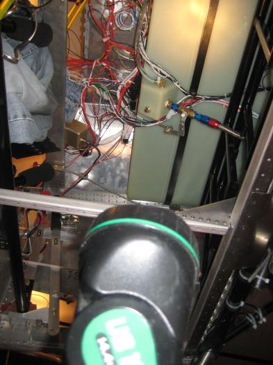 Flashlight shining up to gas tank.