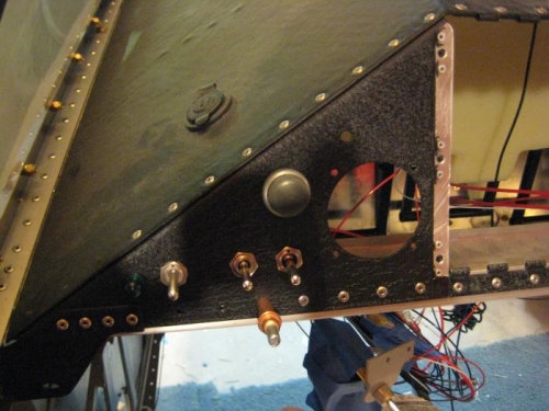 Left panel in place and partially riveted. Radio goes in the large hole.