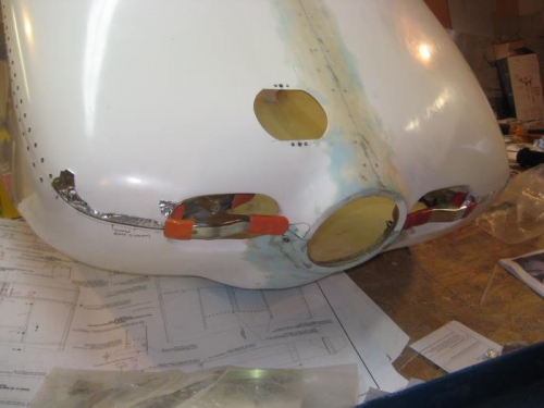 From the outside. The clamps keep the cowl aligned.