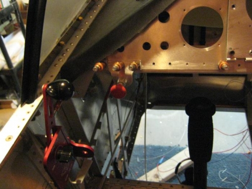 Throttle on left; mixture above and right, attached to the panel.