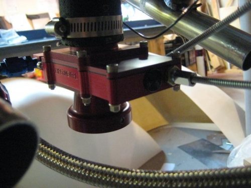 From the rear, the fuel line left, throttle cable right center; mixture above that.