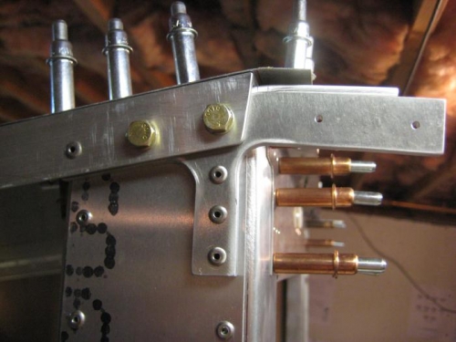 With fuselage on its side, the AN bolts installed and bracket riveted.