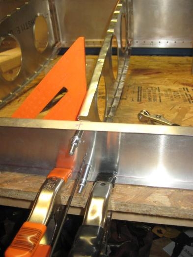 Hold down spar, plumb rib, drill holes, cleco