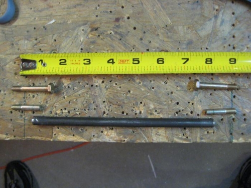 Uncut bolts above; cut bolts below; chromoly tubing at the bottom, cut to length.