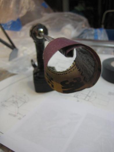 Rod with 40 grit sandpaper, chucked into my drill.