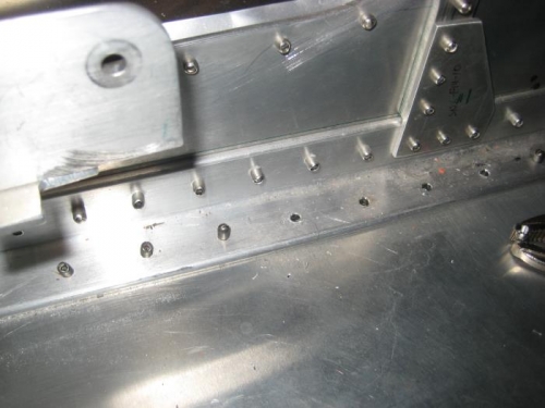 Drill out rivets, align new mounting angle over them, and updrill for new bolts.