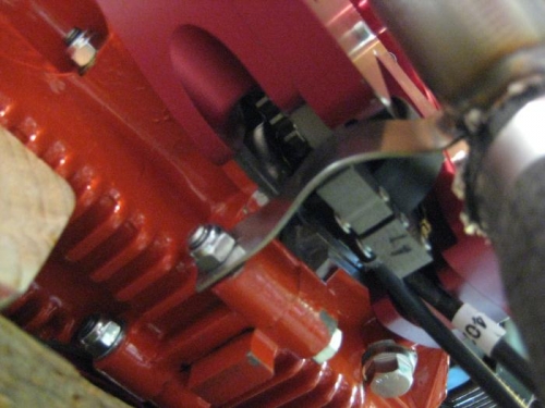 with the bent attachment going around the magnetron, and to the engine case bolt.