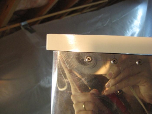 At the trailing edge of the rudder.