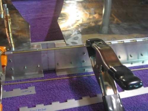 Hinge pin spanning left and right hinges, ensuring both hinges are aligned