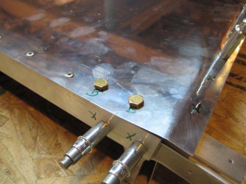 Temporary bolts at lower bracket.