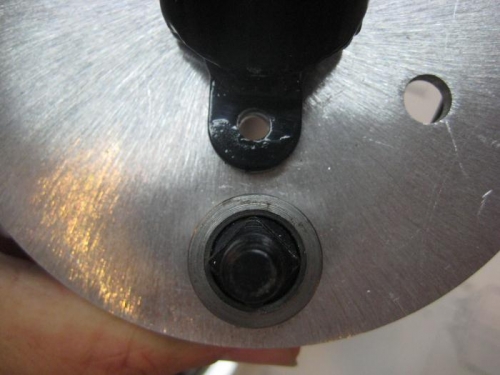 Tab located over drilled hole