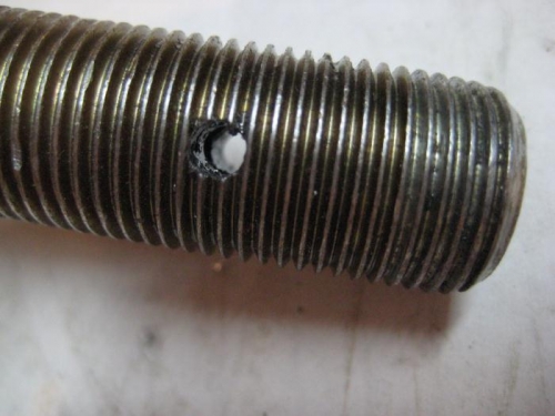 The cotter pin hole in the axle.