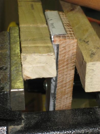 The whole assembly in the vice. The two blocks of wood on either side are the sacrificial pieces.