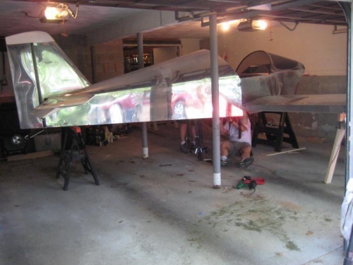 Another view of the airplane in the garge on the sawhorses