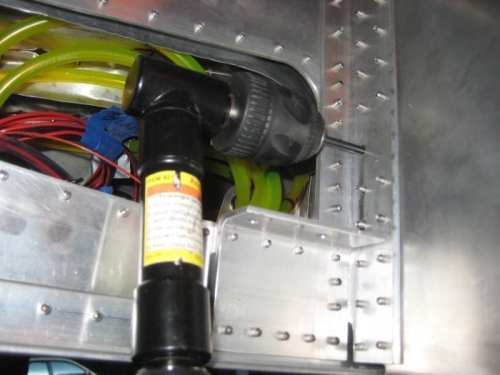 On the right side of the fuselage, looking front to rear, drilling the revese under-sized hole.