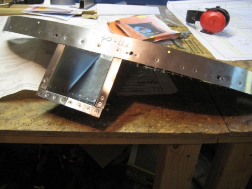 Riveted strap to upper firewall