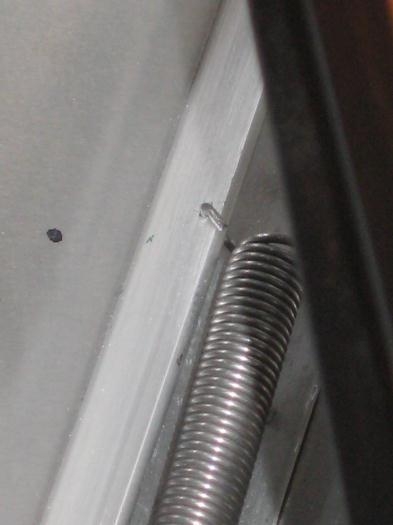 Hole drilled in diagonal longeron for spring