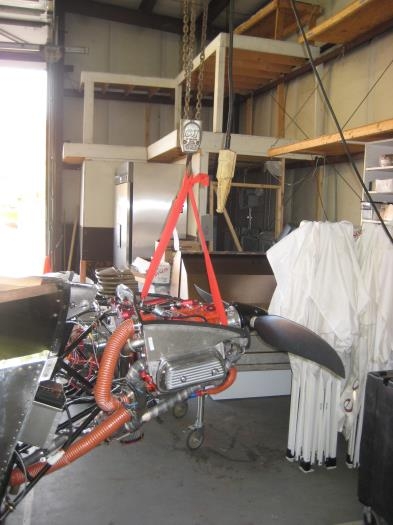 Engine hoist holding the engine up and forward.