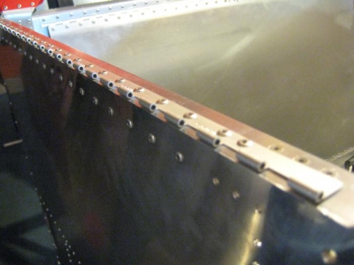 Hinge half riveted in place