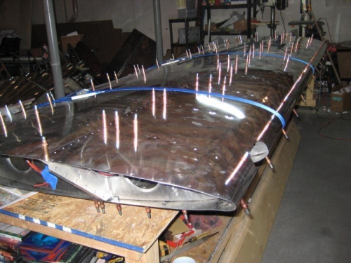 Skin held in place after dimpling, to check fit of rivets through skin-and-ribs