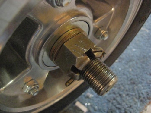 Axle nut with 2 washers behind.