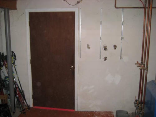 3' door on left; test holes in wall on right.