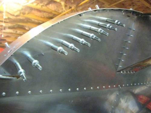 New holes cleco'd from the forward face of the firewall