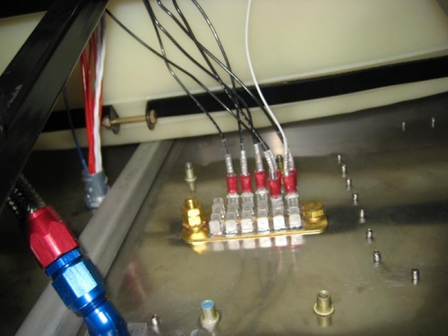 Ground block at the upper firewall, inside the cockpit.