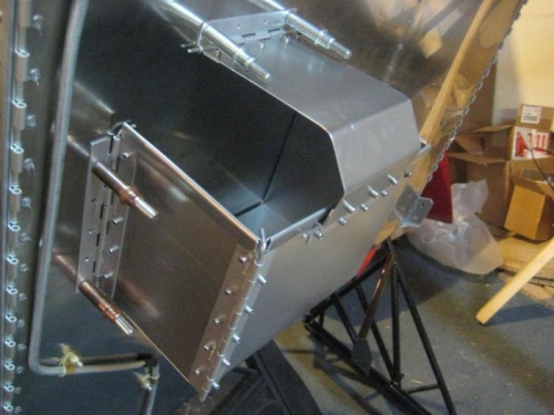 Side hinges are for removal so the battery can be taken out sideways.