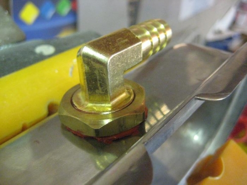 A 90 degree brass fitting with a stop nut outside...