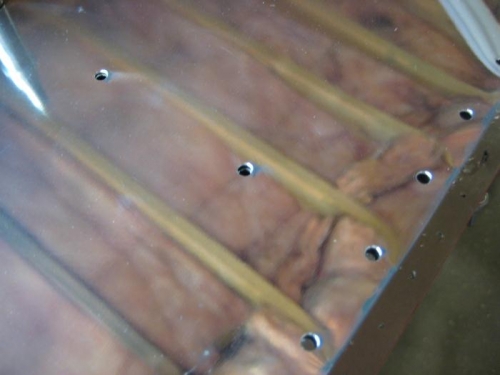 Updrilled for rivets (with reflection of ceiling above)
