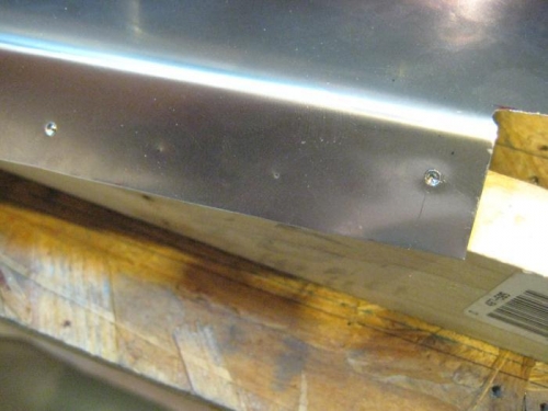 Drilling thru the stainless is a bear! The dent at the right is 5 minutes of work with no success.
