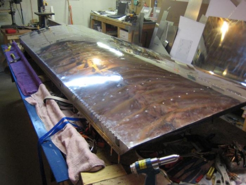 Upper aft skin all riveted.