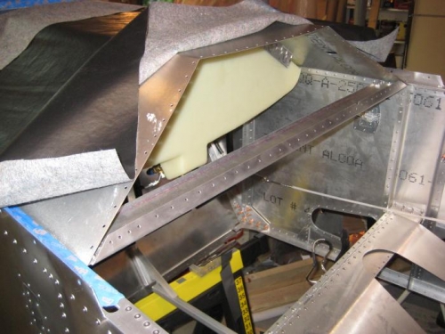 Lower cross member of instrument panel riveted in place.