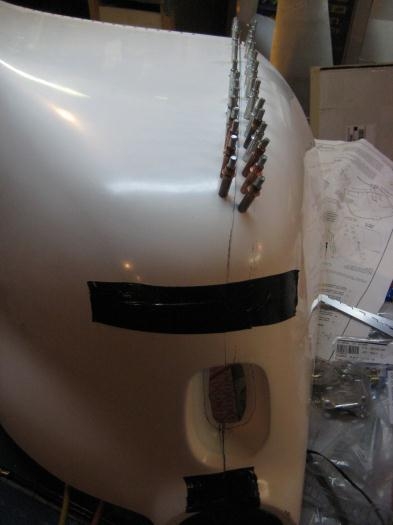 Cowl on the work bench and holes bein updrilled.