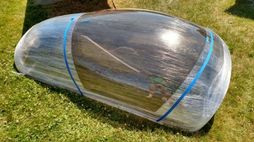 Old canopy laid over new canopy material.