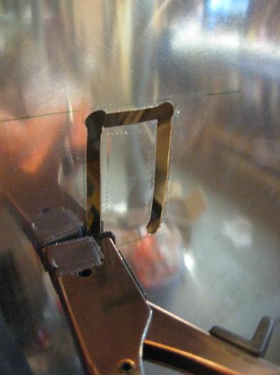 Using the nibbler to cut out the rough hole.