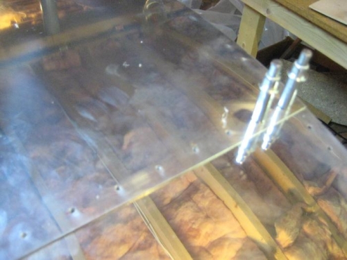 Leading edge UNDER the aft top skin, for locating holes in leading edge skin (rafters in reflection).