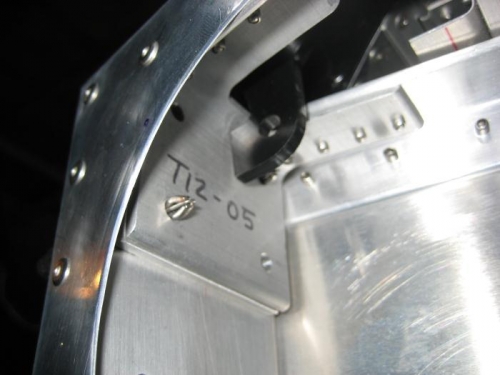 Up-elevator stop is not hitting flush, and is striking the filet of the T12-05 angle.