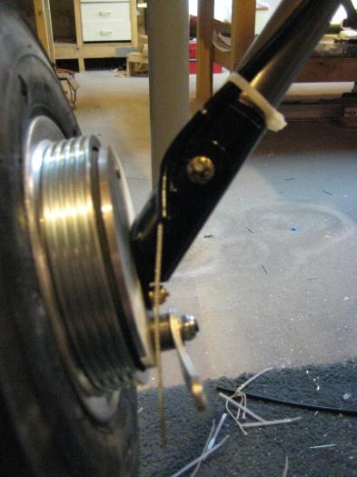 Brake cable at left gear leg.