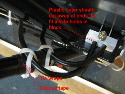 Brake cable housings at the engine mount block.