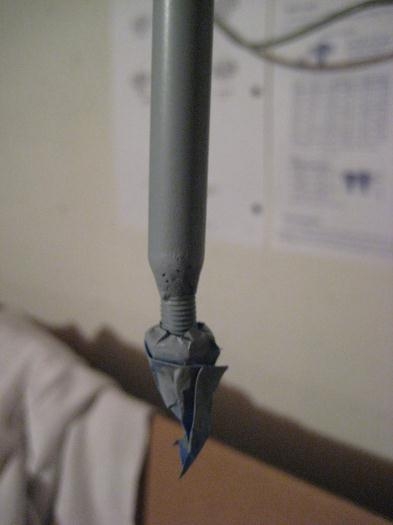 Closeup of one end. There is a nut and the rest of the threads under the tape.