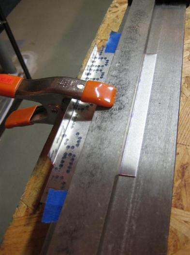 The solid bar of the brake goes on top, and the spring clamp holds it in alignment.